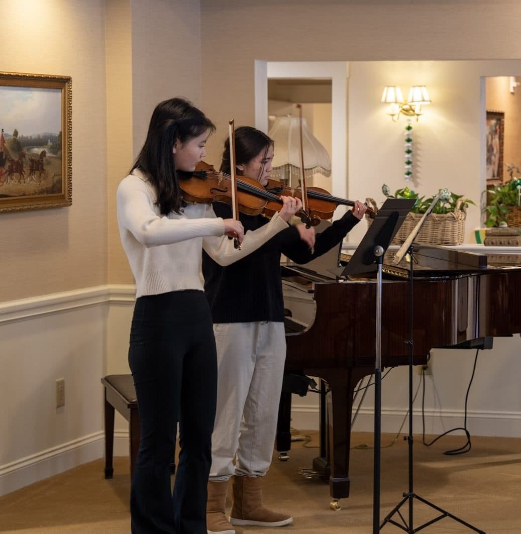 A musical performance for residents seated in a semicircle