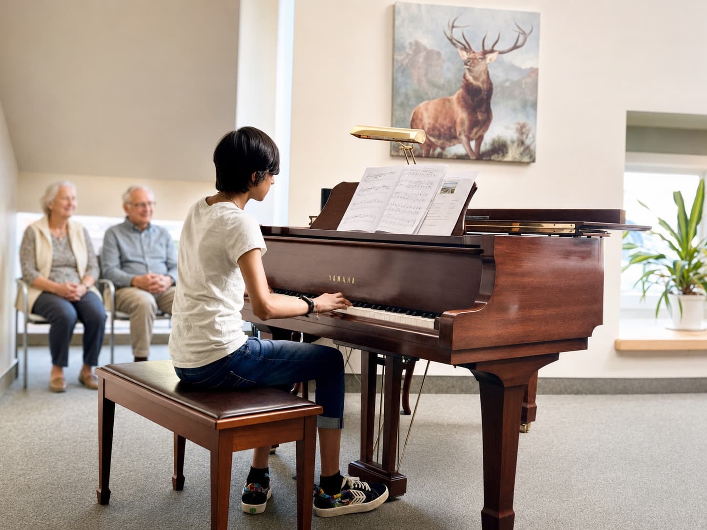 A young pianist performs for residents in a senior community