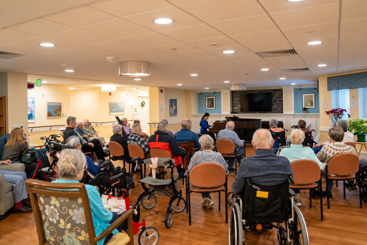 A young pianist performs for a full room of older adults at Kendal at Hanover